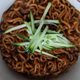 chapagetti prepared in bowl with cucumber